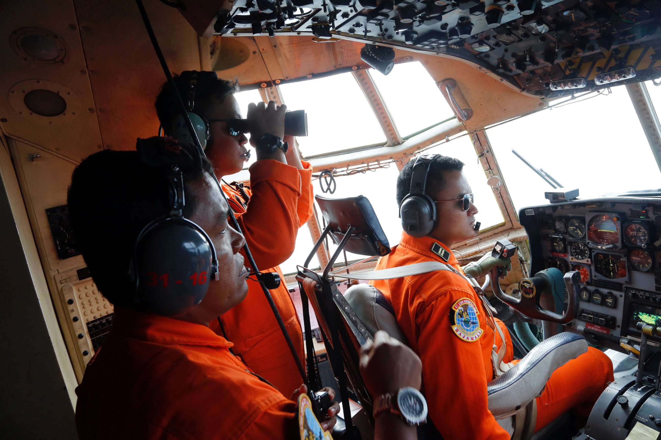 PHOTO: Crew of Indonesian Air Force C-130 airplane scan the horizon while searching for the missing AirAsia flight 8501 jetliner over the waters of Karimata Strait in Indonesia, Dec. 29, 2014.