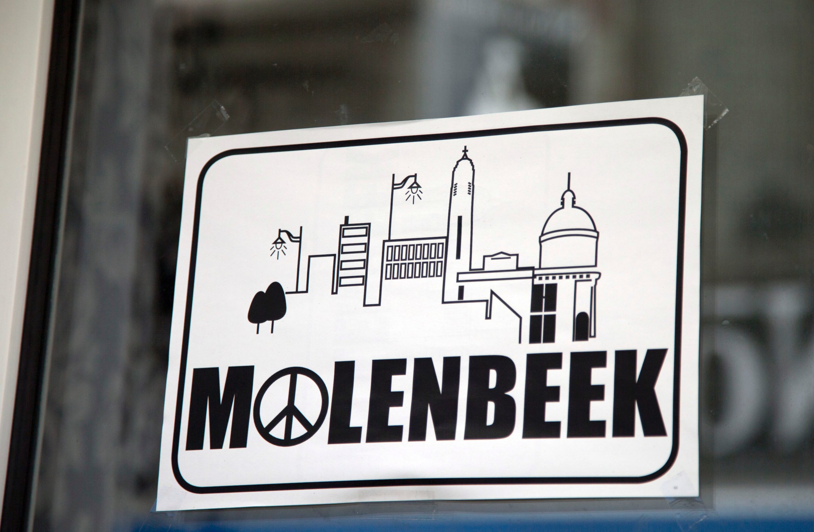 PHOTO: A sign in a shop window reads Molenbeek with a peace sign, on the main shopping street of Molenbeek, Belgium, Nov. 18, 2015. 