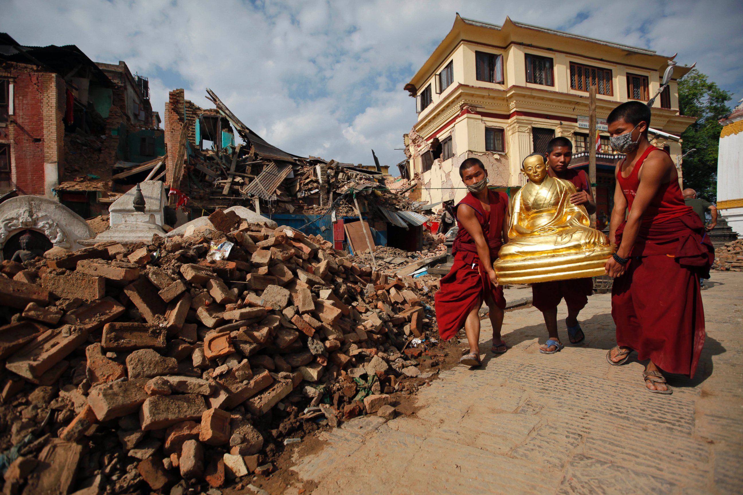 PHOTO: Buddhist monks salvage a statue of a Buddhist deity from a monastery around the famous Swayambhunath stupa after it was damaged by Saturday's earthquake in  Kathmandu, Nepal, April 30, 2015.