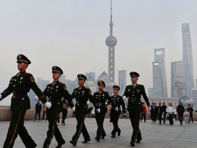 PHOTO: Chinese paramilitary police personnel patrol along the Bund, a popular tourist attraction in Shanghai, China, Dec. 31, 2015.