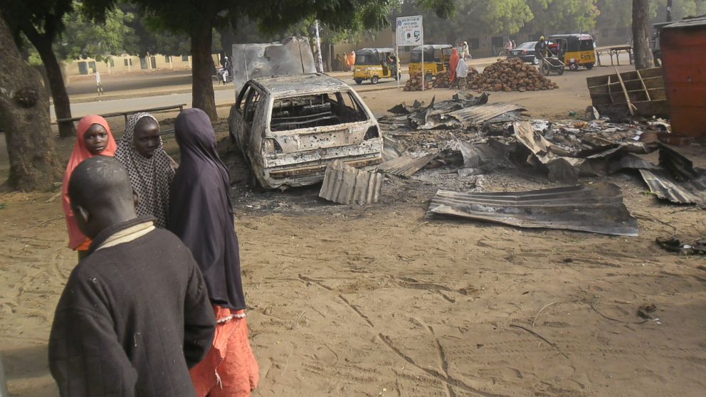 PHOTO: Children stand near the scene of an explosion in a mobile phone market in Potiskum, Nigeria,  Jan. 12, 2015. 