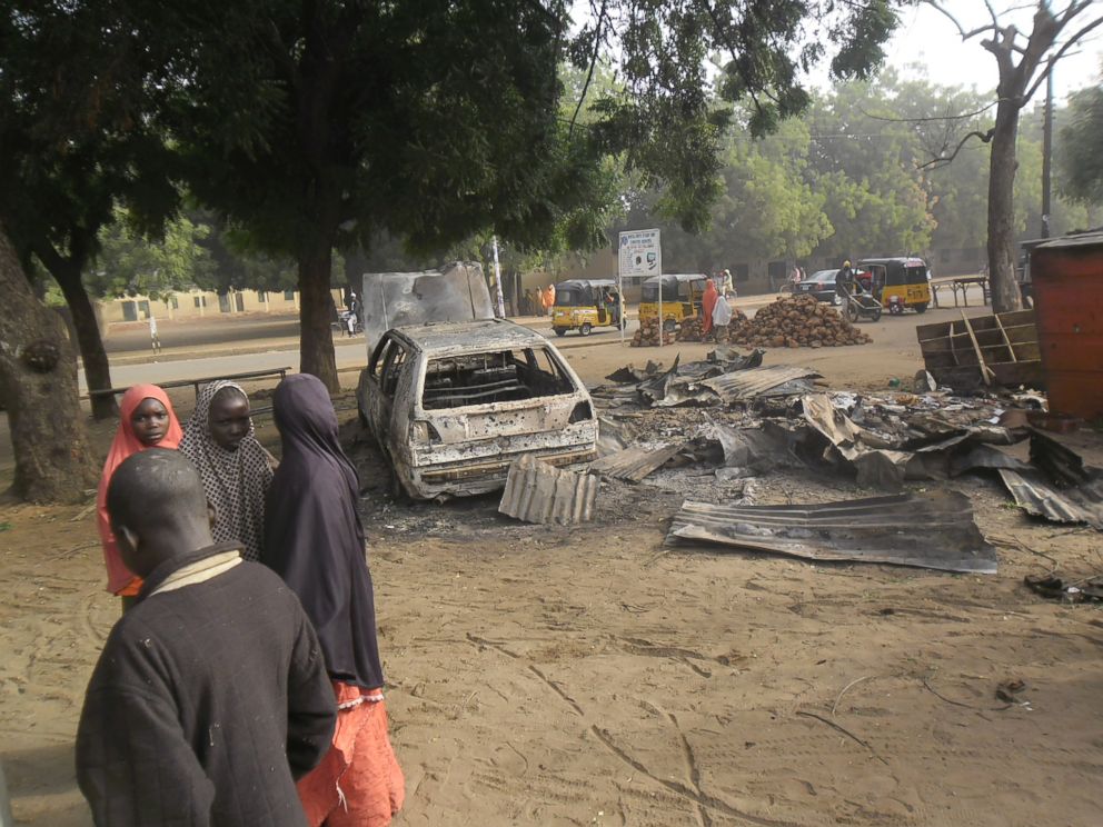 PHOTO: Children stand near the scene of an explosion in a mobile phone market in Potiskum, Nigeria,  Jan. 12, 2015. 