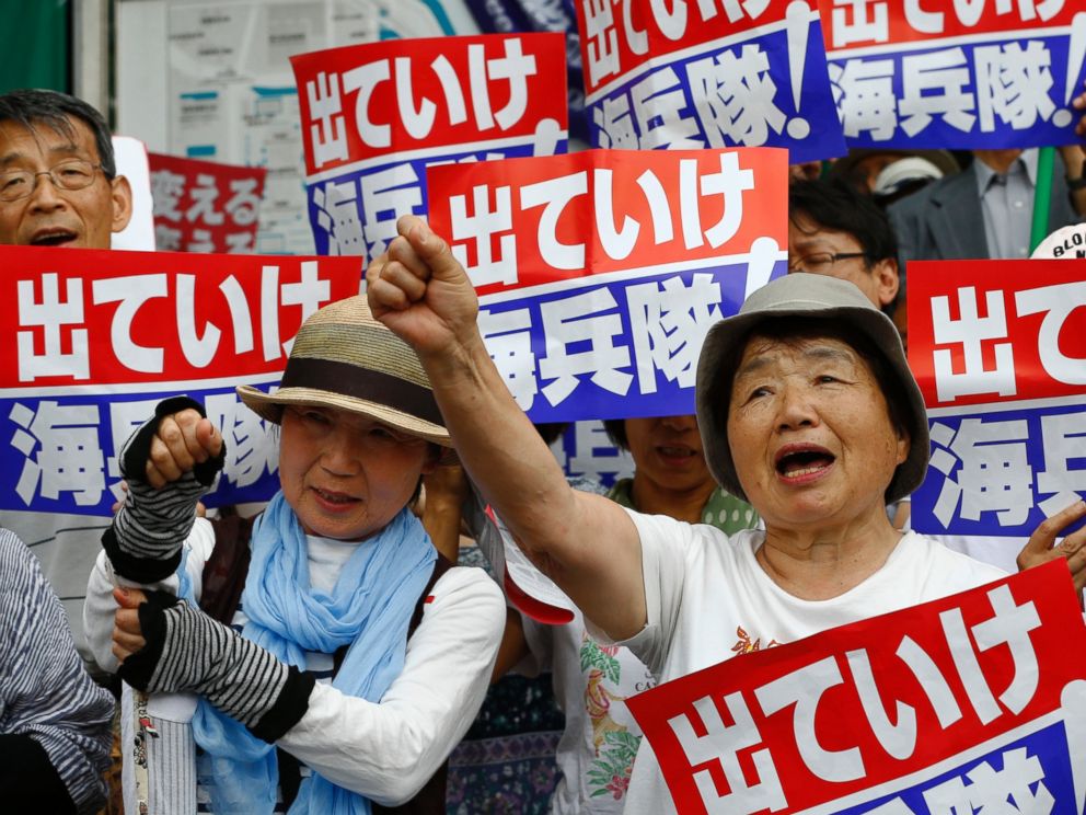 PHOTO: Protesters shouts slogans at an anti-U.S. base rally in front of the National Diet building in Tokyo, Japan, June 19, 2016.