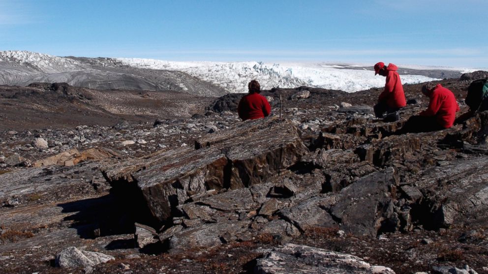 PHOTO: A field team examines rocks in Greenland in July 2012.