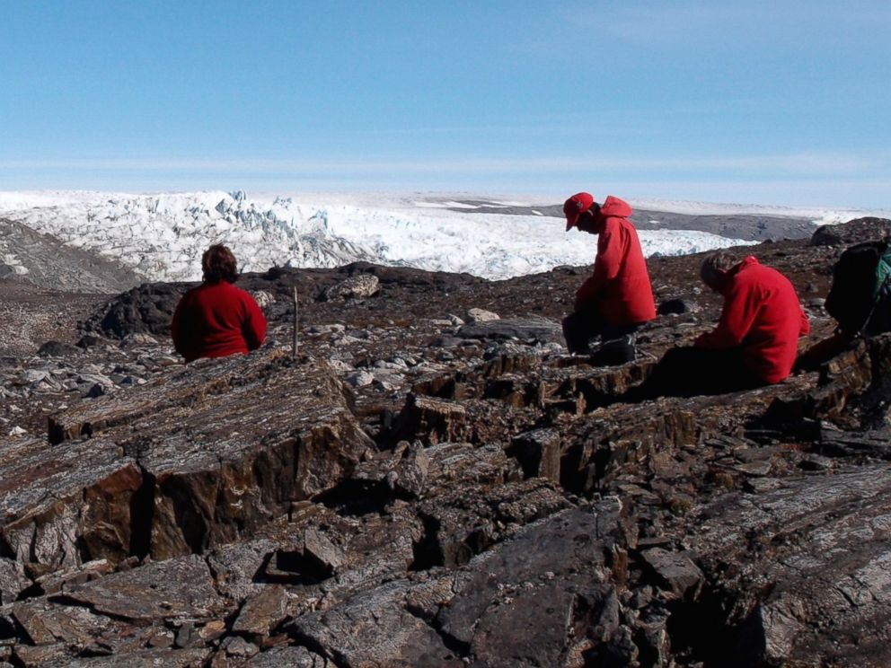 PHOTO: A field team examines rocks in Greenland in July 2012.