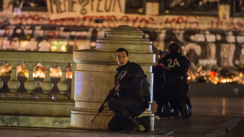 PHOTO: French police officers take position on Place de la Republique after allegedly false alert sparked mass panic amongst the gathered crowd in Paris on Nov. 15, 2015.