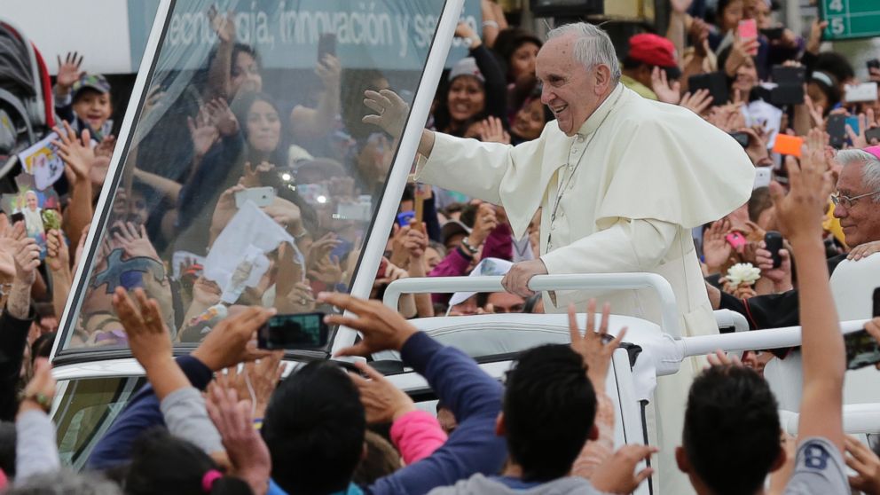 Pope Francis waves to the crowd as he rides aboard the Popemobile in the streets of Quito, Ecuador, Sunday, July 5, 2015. Francis is making his first visit as pope to his Spanish-speaking neighborhood.