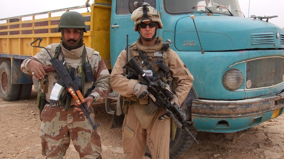 This 2007 photo provided by Chase Millsap shows Millsap with the Captain standing next to a suspected truck bomb following a successful raid in Al Anbar, Iraq.