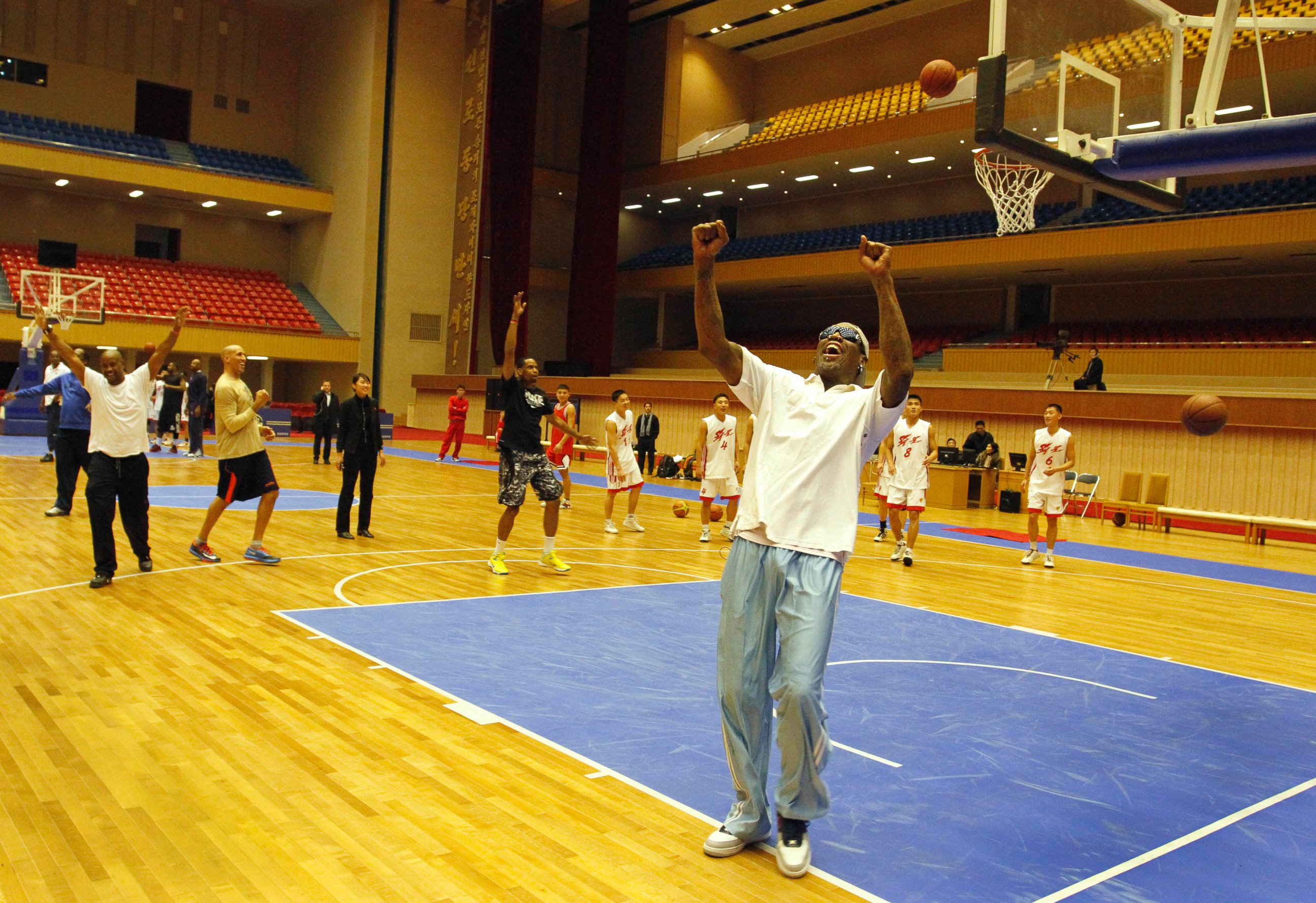 PHOTO: Dennis Rodman cheers after a fellow U.S. basketball player makes a jump shot during a practice session with North Korean players in Pyongyang, North Korea on Jan. 7, 2014. 