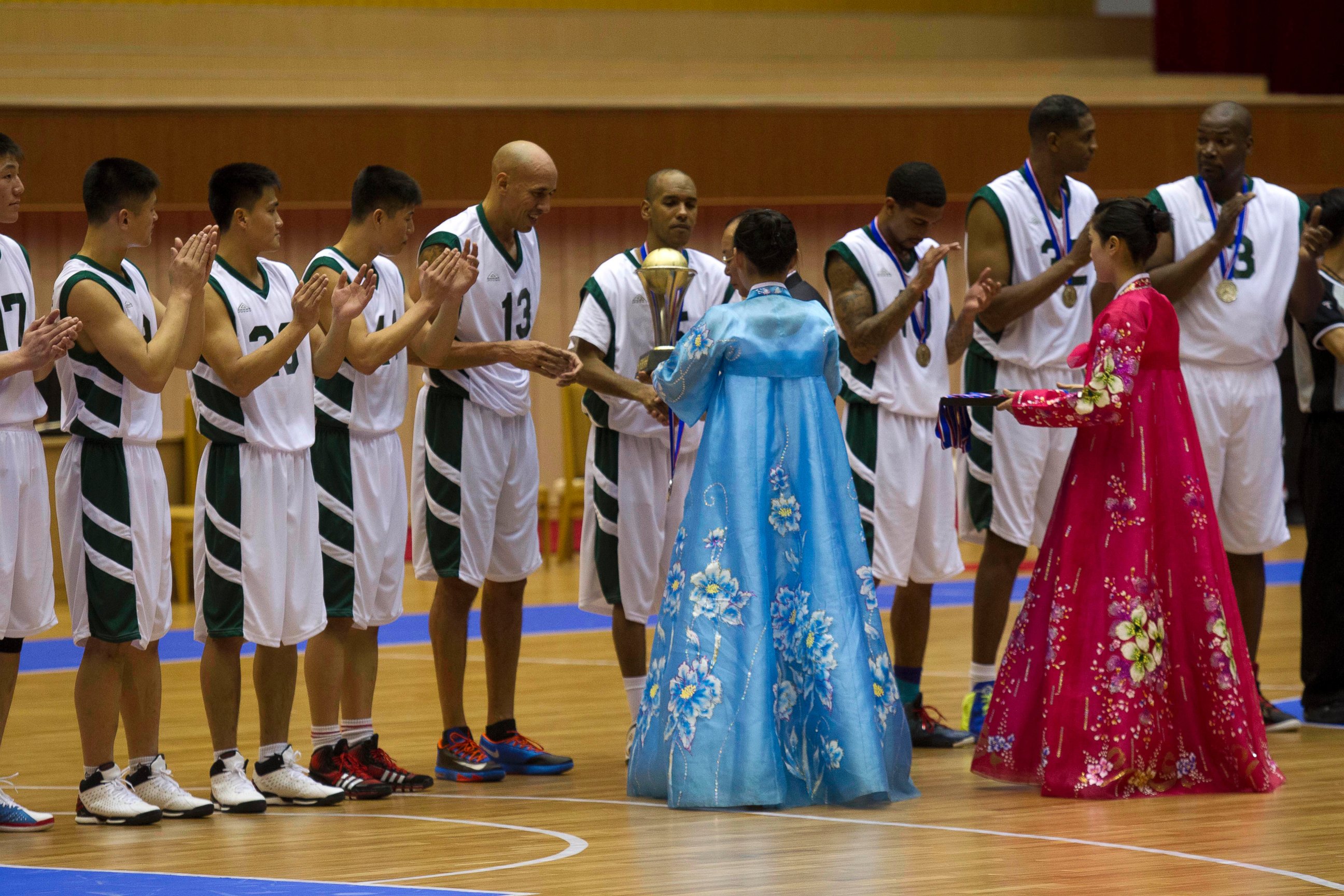PHOTO: U.S. basketball player Doug Christie is handed a trophy as North Korean players applaud at the end of an exhibition basketball game at an indoor stadium in Pyongyang, North Korea on Jan. 8, 2014. 