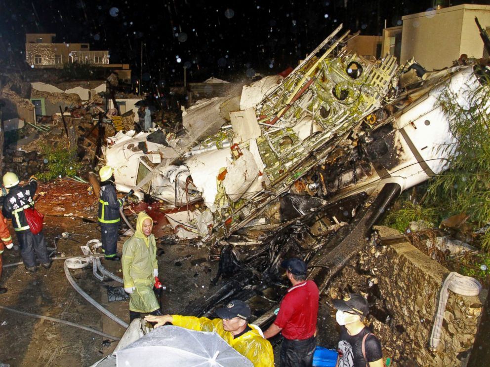 PHOTO: Rescue workers work next to the wreckage of TransAsia Airways flight GE222 which crashed while attempting to land in stormy weather on the Taiwanese island of Penghu, July 23, 2014.
