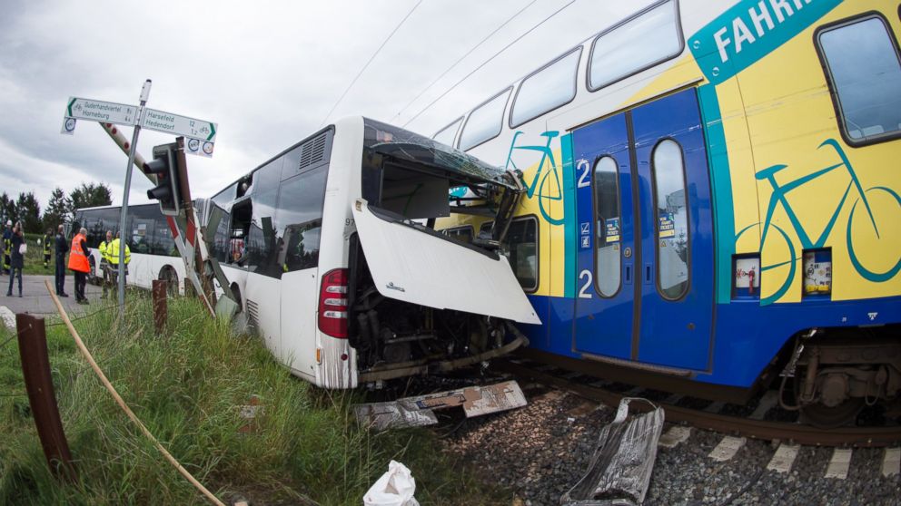 The wreckage of a school bus and a train stand on a railway crossing near Buxtehude, northern Germany, Sept. 16, 2015. The train hit the bus that was stuck on the railway crossing shortly after the bus driver evacuated around 60 children from the vehicle.