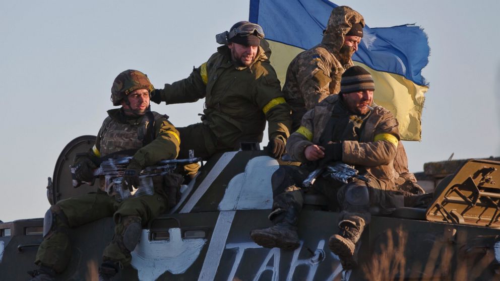Ukrainian troops ride on an armored vehicle outside Artemivsk, Ukraine, while pulling out of Debaltseve, Feb. 18, 2015. After weeks of relentless fighting, the embattled Ukrainian rail hub of Debaltseve fell to Russia-backed separatists, who hoisted a flag in triumph over the town. 