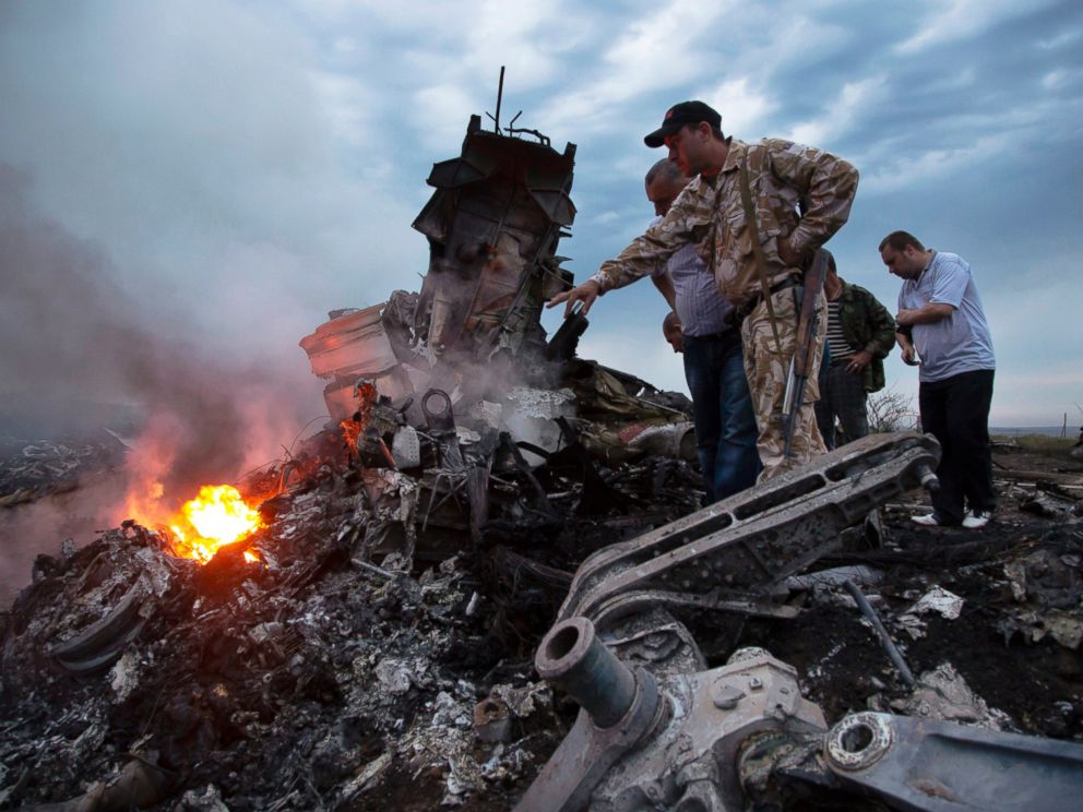 PHOTO: People inspect the crash site of Air Malaysia flight MH17 near the village of Grabovo, Ukraine, July 17, 2014.