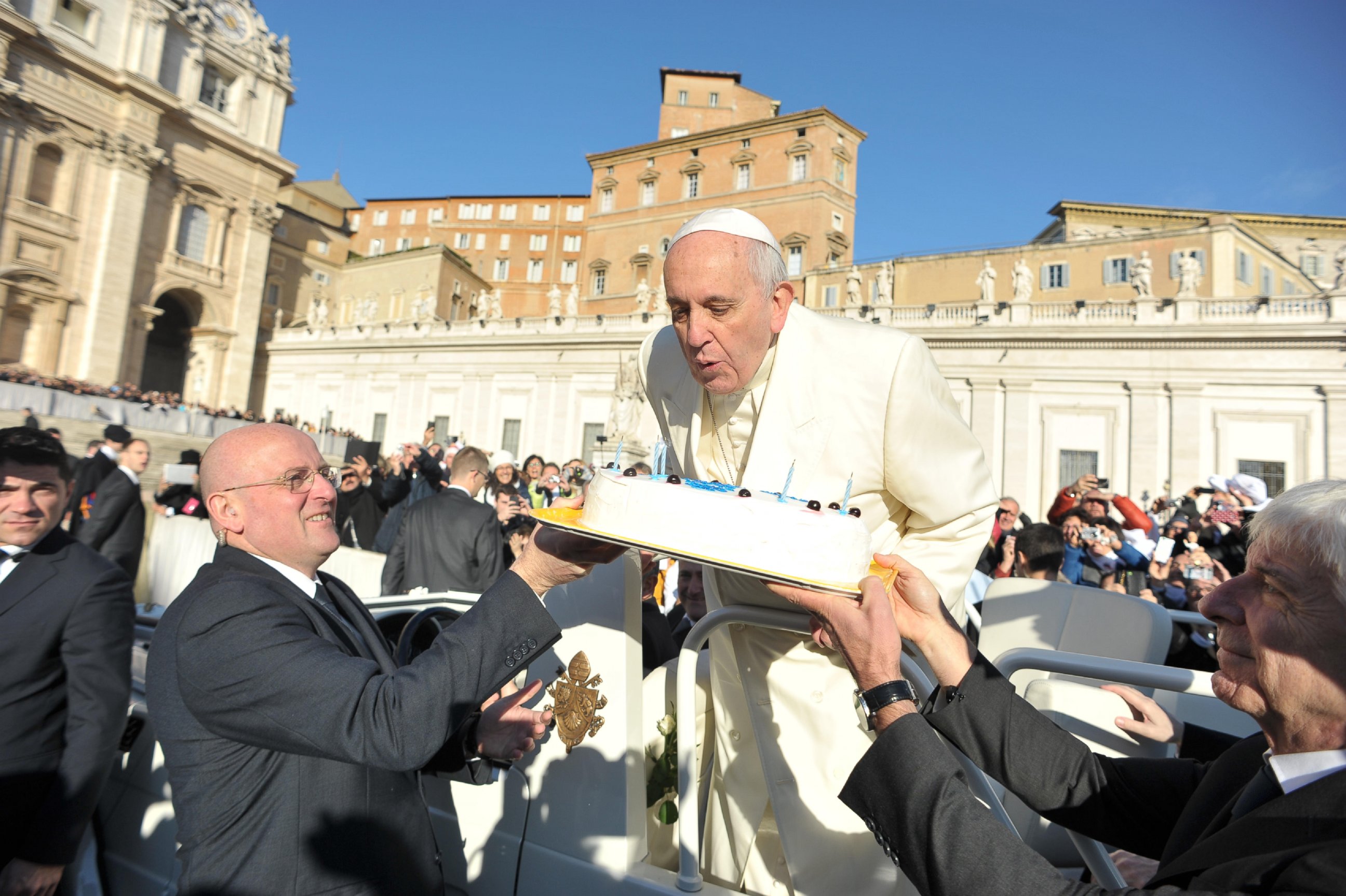 PHOTO: In this photo provided by Vatican newspaper L'Osservatore Romano, Pope Francis blows candles on a cake during his weekly general audience in St. Peter's Square at the Vatican on Dec. 17, 2014.