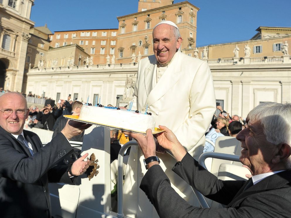 PHOTO: In this photo provided by Vatican newspaper LOsservatore Romano, Pope Francis is presented with a cake during his weekly general audience in St. Peters Square at the Vatican on Dec. 17, 2014.