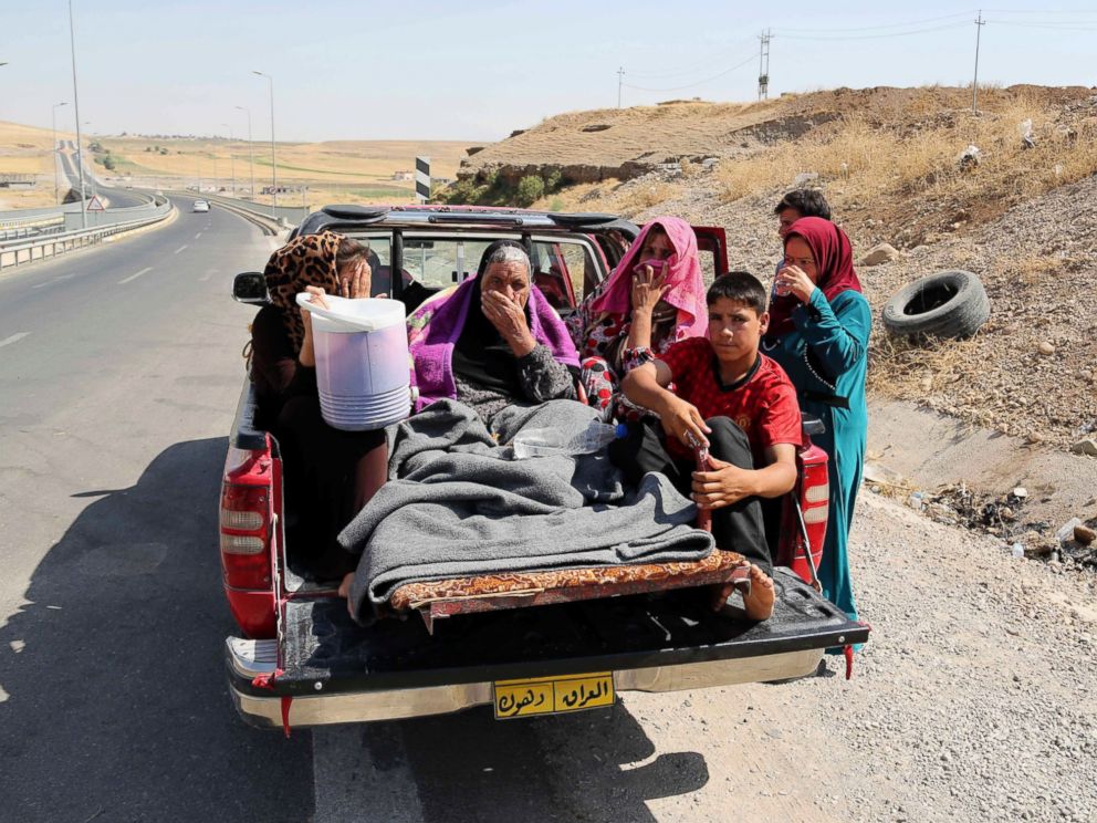 PHOTO: Displaced Iraqis ride on a truck on a mountain road near the Turkish-Iraq border, outside Dahuk, in Iraq Saturday, Aug. 9, 2014.