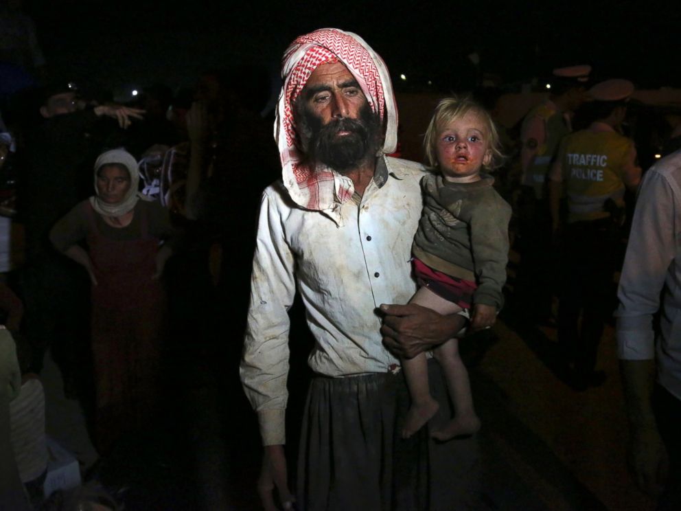 PHOTO: Displaced Iraqis from the Yazidi community cross the Syria-Iraq border at Feeshkhabour border point, in northern Iraq, Aug. 10, 2014.