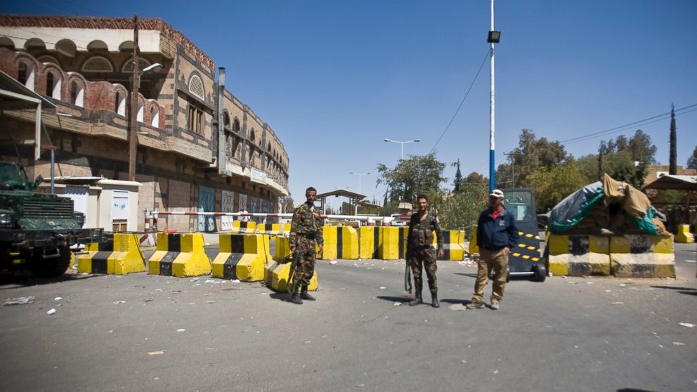 Police troopers stand guard at the entrance of the U.S. Embassy in Sanaa, Yemen, Feb. 11, 2015. 