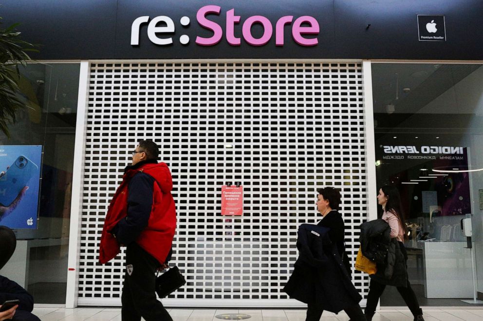 PHOTO: Shoppers walk past a closed 're:Store', an Apple reseller shop in a shopping mall in Omsk, Russia, March 2, 2022. 