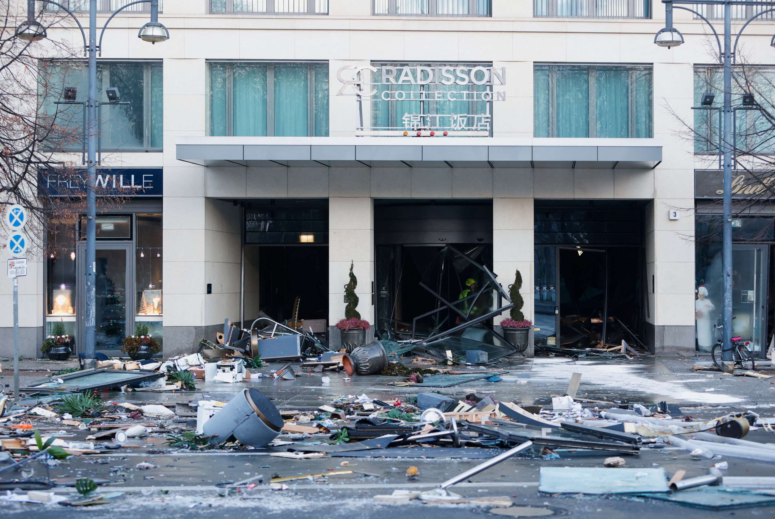 PHOTO: Debris covers a street outside a hotel after the AquaDom aquarium burst inside the hotel in Berlin, Dec. 16, 2022.