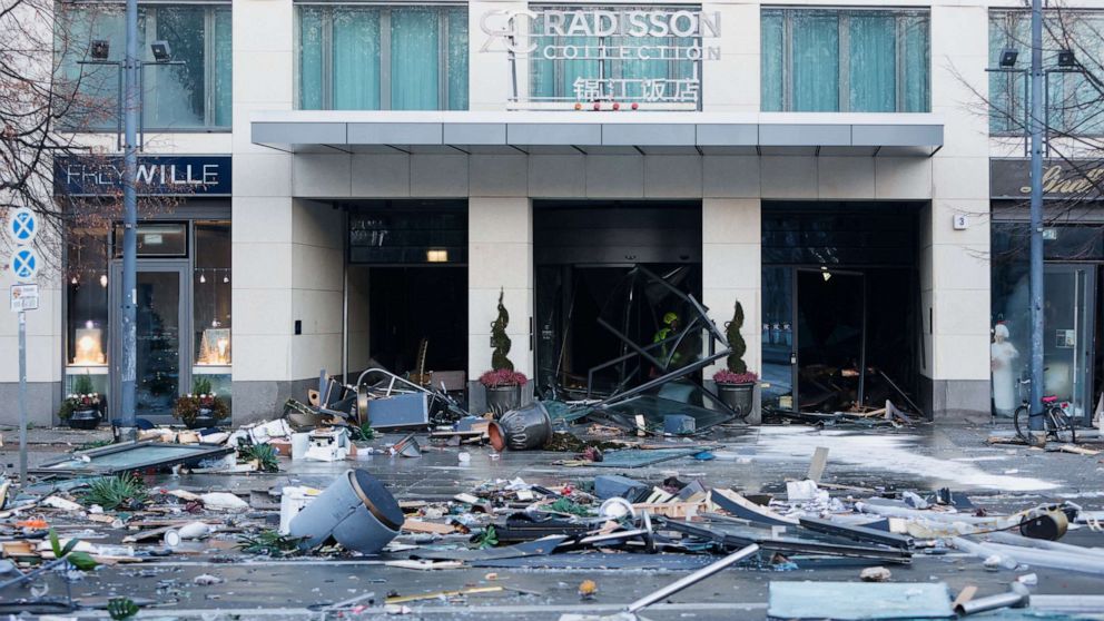 PHOTO: Debris covers a street in front of a hotel after the hotel's AquaDom aquarium exploded in Berlin, Germany, December 16, 2022.