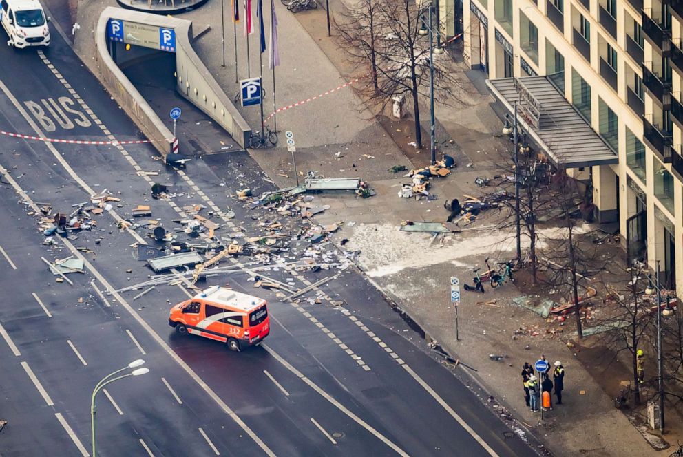 PHOTO: Debris covers the street in front of a hotel after an aquarium inside the hotel burst December 16, 2022 in Berlin, Germany.