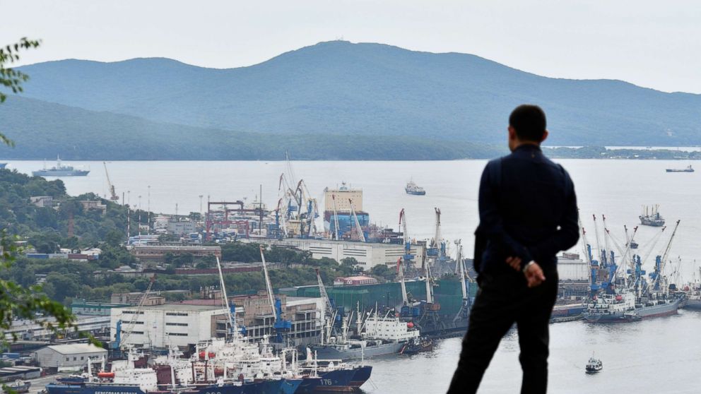 A man watches the Venta Maersk in the Russian port of Vladivostok as it prepares to set off on its Arctic voyage, Russia Aug. 22, 2018.