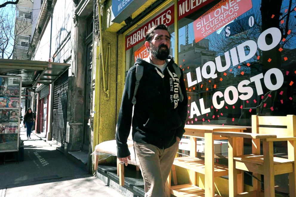 PHOTO: A man walks past a store closing sale in Buenos Aires, Sept. 4, 2018.