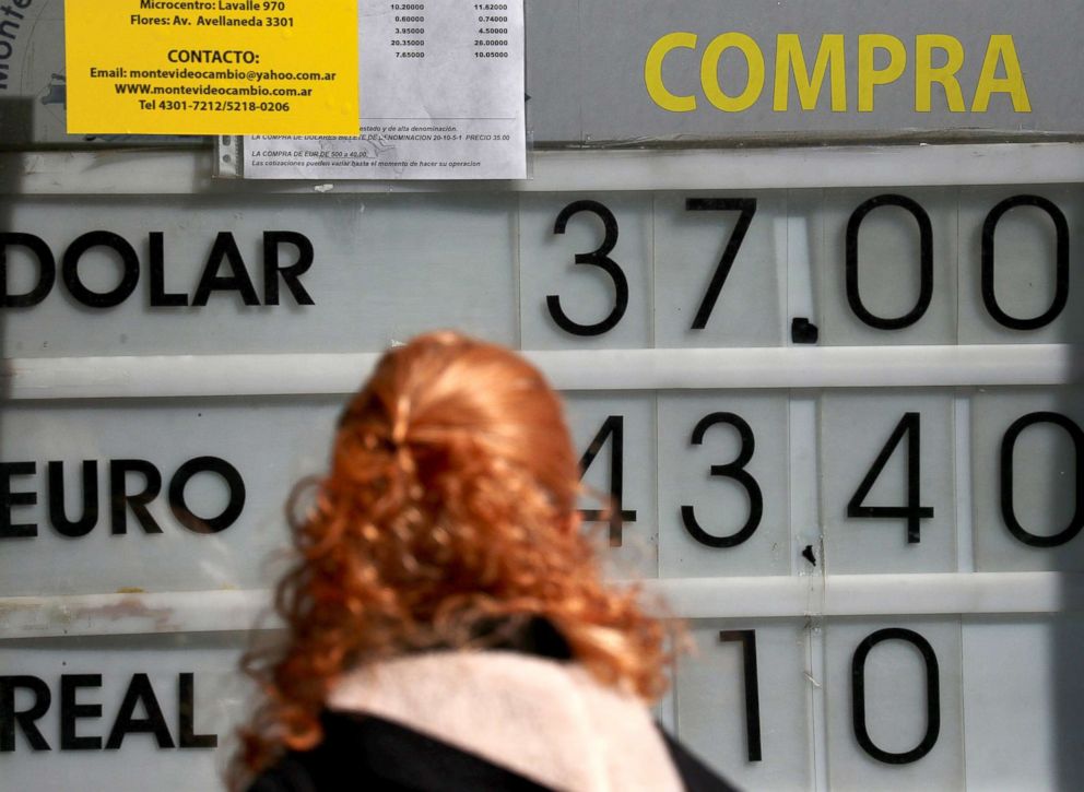 PHOTO: A woman looks at a currency exchange board in Buenos Aires, Sept. 5, 2018. 