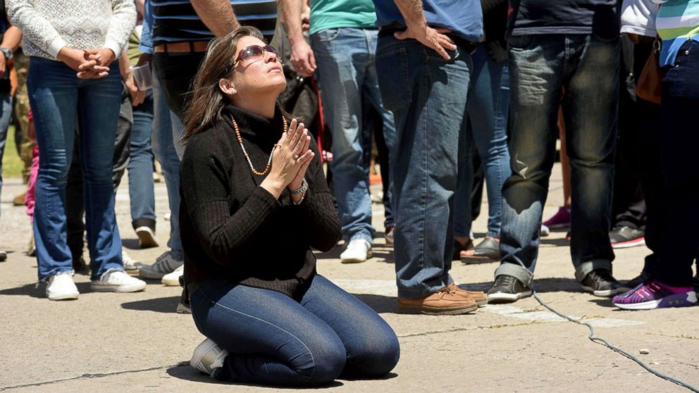 A relative of missing Argentine submarine crew member Celso Oscar Vallejos kneels down to pray, outside Argentina's Navy base in Mar del Plata, on the Atlantic coast south of Buenos Aires, on Nov. 25, 2017. 