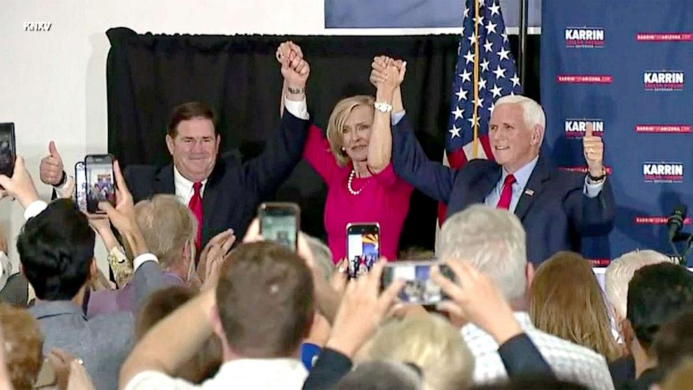 PHOTO: Karin Taylor Robson (center) is joined by Gov.Doug Ducey and former Vice-President Mike Pence at an election campaign event in Peoria, Ariz., July 24, 2022.