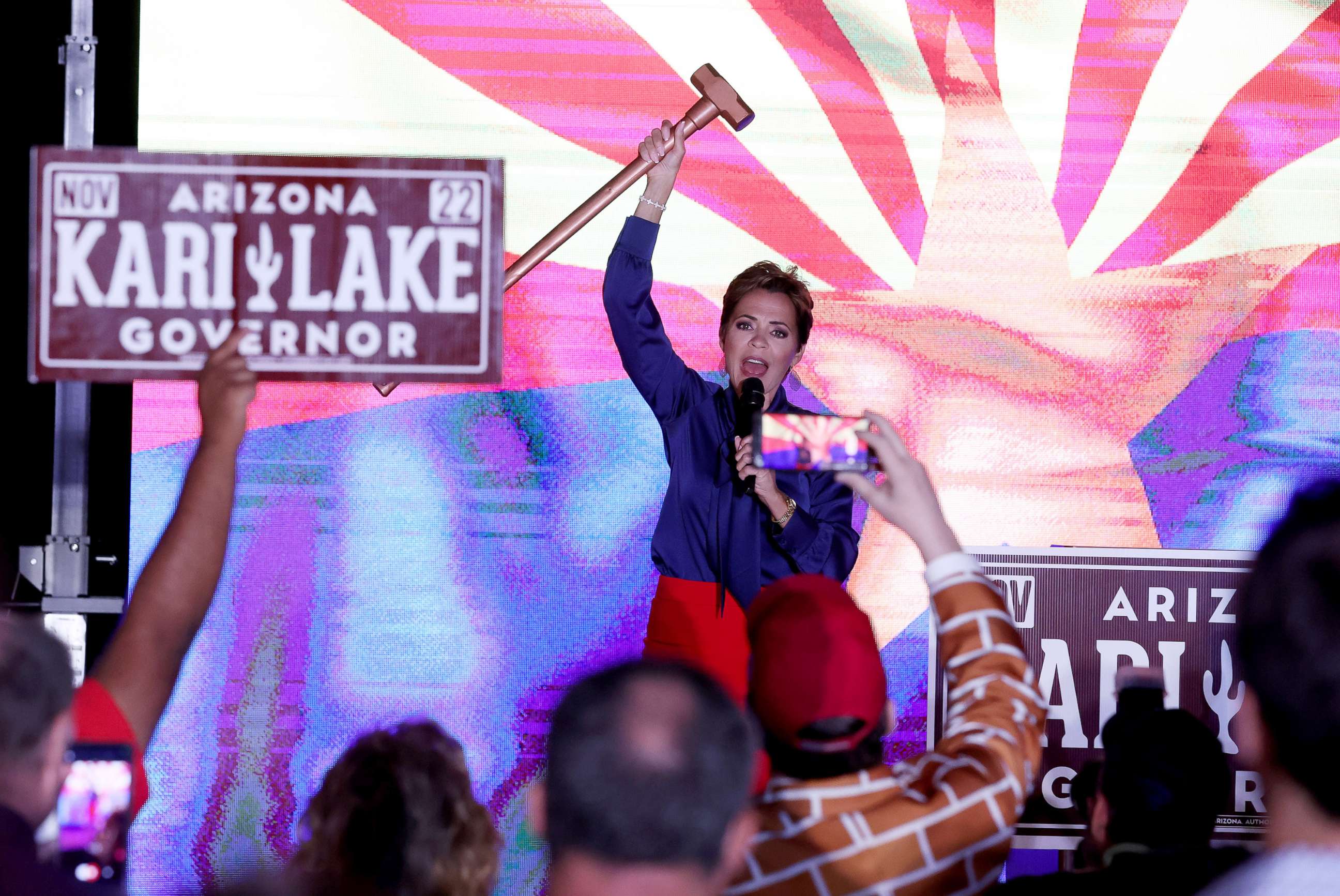 PHOTO: Republican candidate for Arizona Governor Kari Lake holds up a sledgehammer as she speaks to supporters that are waiting around as ballots continue to be counted during her primary election night gathering in Scottsdale, Ariz., Aug. 3, 2022.