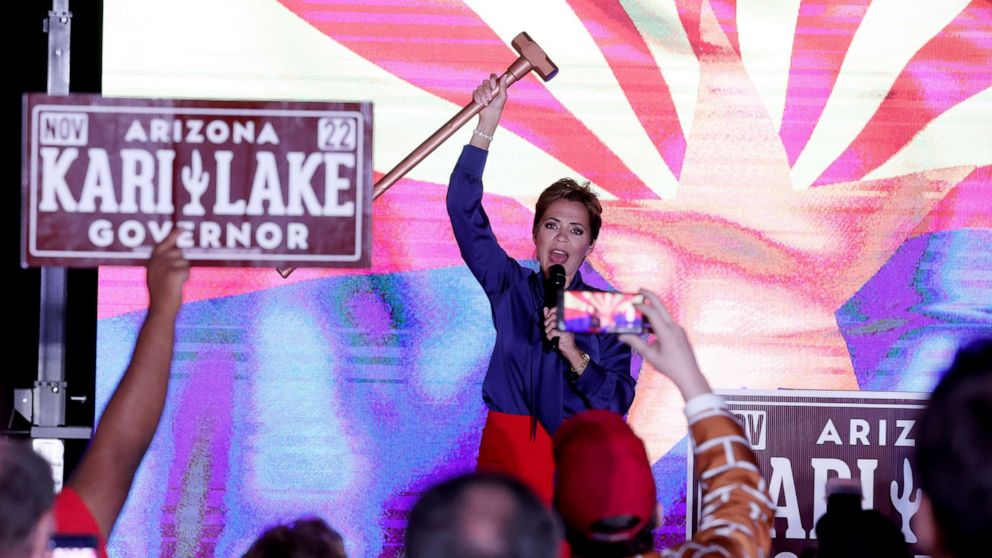 PHOTO: Republican candidate for governor of Arizona, Kari Lake, holds up a sledgehammer as she speaks to supporters waiting as ballots are counted at her primary election night rally in Scottsdale, Arizona, Aug. 3, 2022.