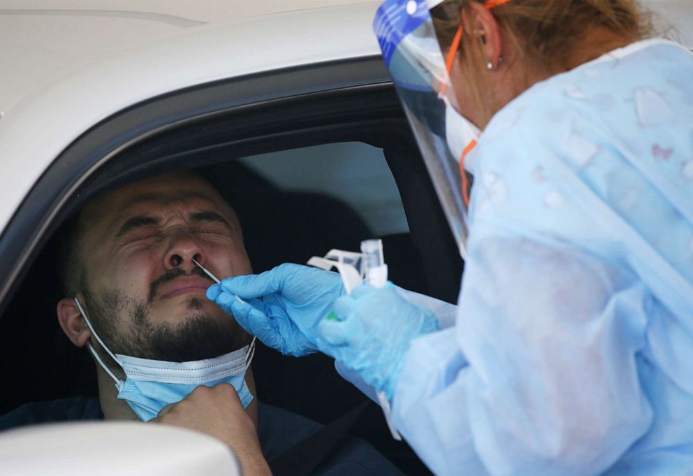 PHOTO: A man gets tested at a drive thru coronavirus testing site at South Mountain Community College in Phoenix, July 9, 2020.
