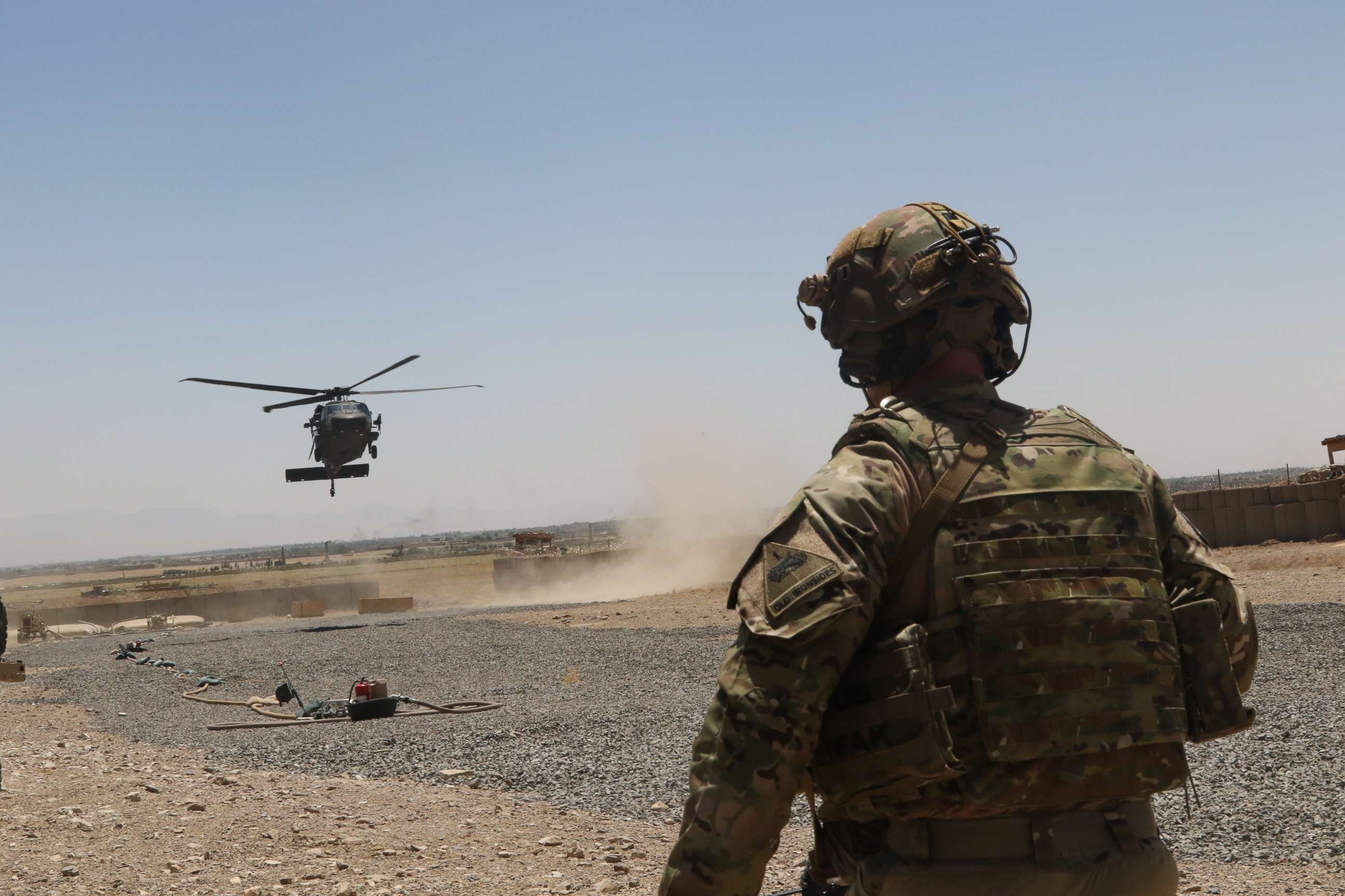 PHOTO: A Soldier watches as a UH-60 Blackhawk Helicopter prepares to land during an advise and assistance mission in southeastern Afghanistan, Aug. 4, 2019.
