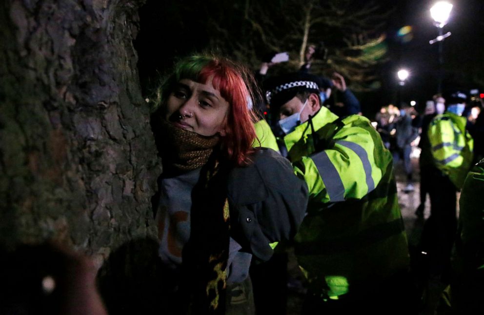 PHOTO: A woman is arrested during a vigil for Sarah Everard on Clapham Common on March 13, 2021 in London, United Kingdom. Vigils are being held across the United Kingdom in memory of Everard.