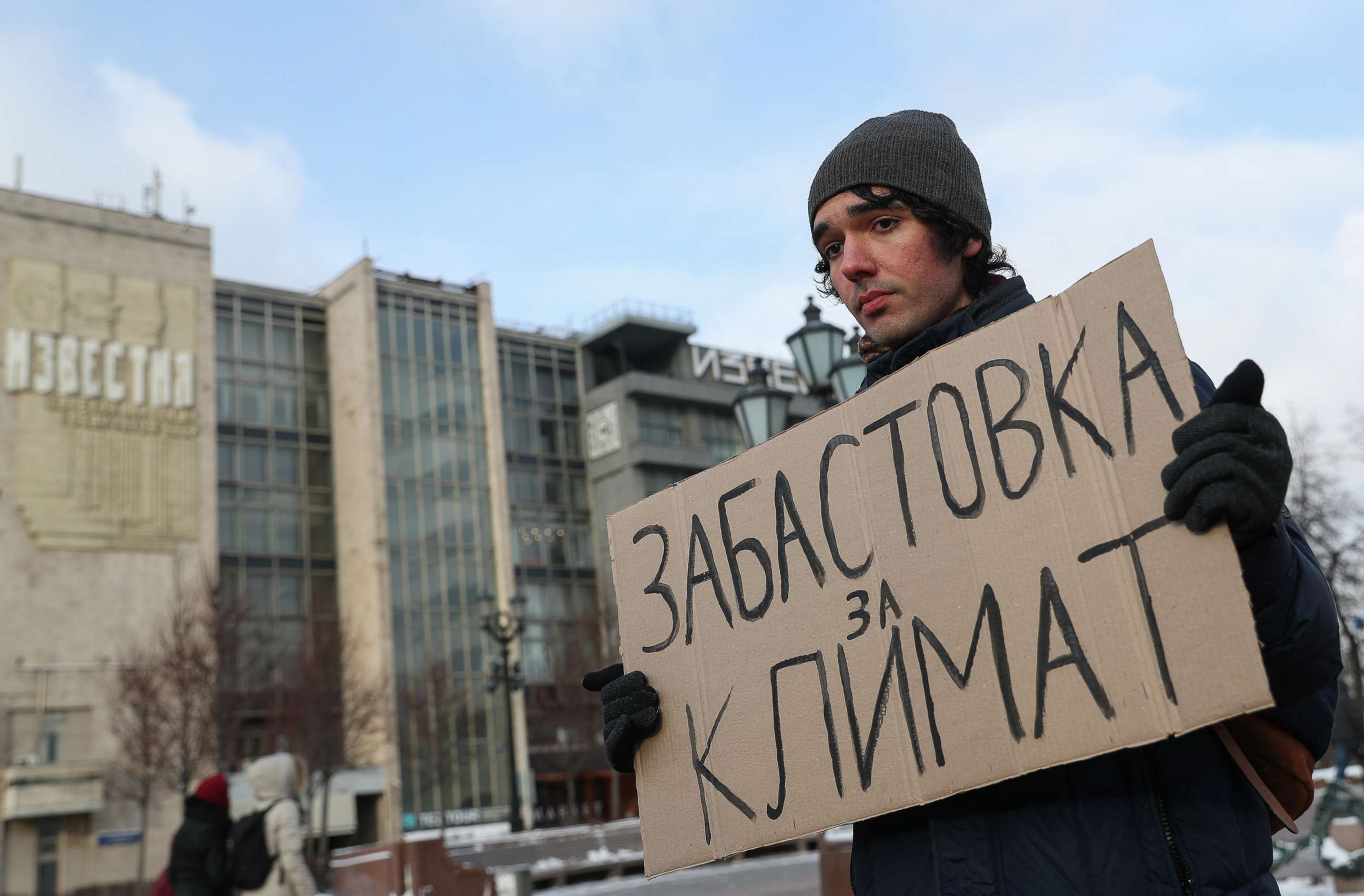 PHOTO: Climate activist Arshak Makichyan holds a cardboard reading "Strike for Climate" during a single-person demonstration in Moscow, Feb. 7, 2020.