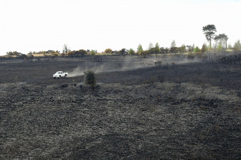 PHOTO: A forest ranger drives over the burned landscape, the scene of a fire at Ashdown Forest, southern England, April 29, 2019.