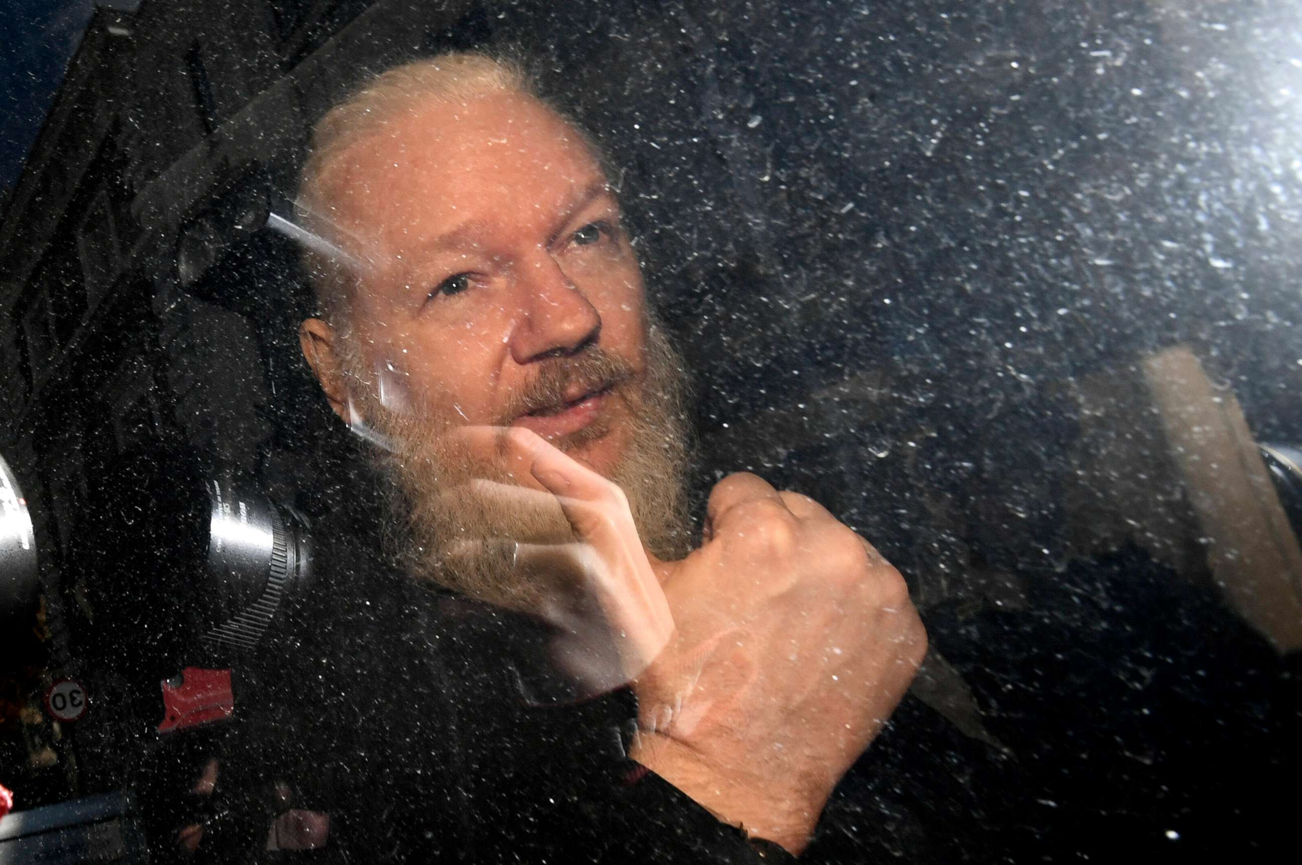 PHOTO: Julian Assange gestures as he arrives at Westminster Magistrates' Court in London, after the WikiLeaks founder was arrested by officers from the Metropolitan Police, April 11, 2019.