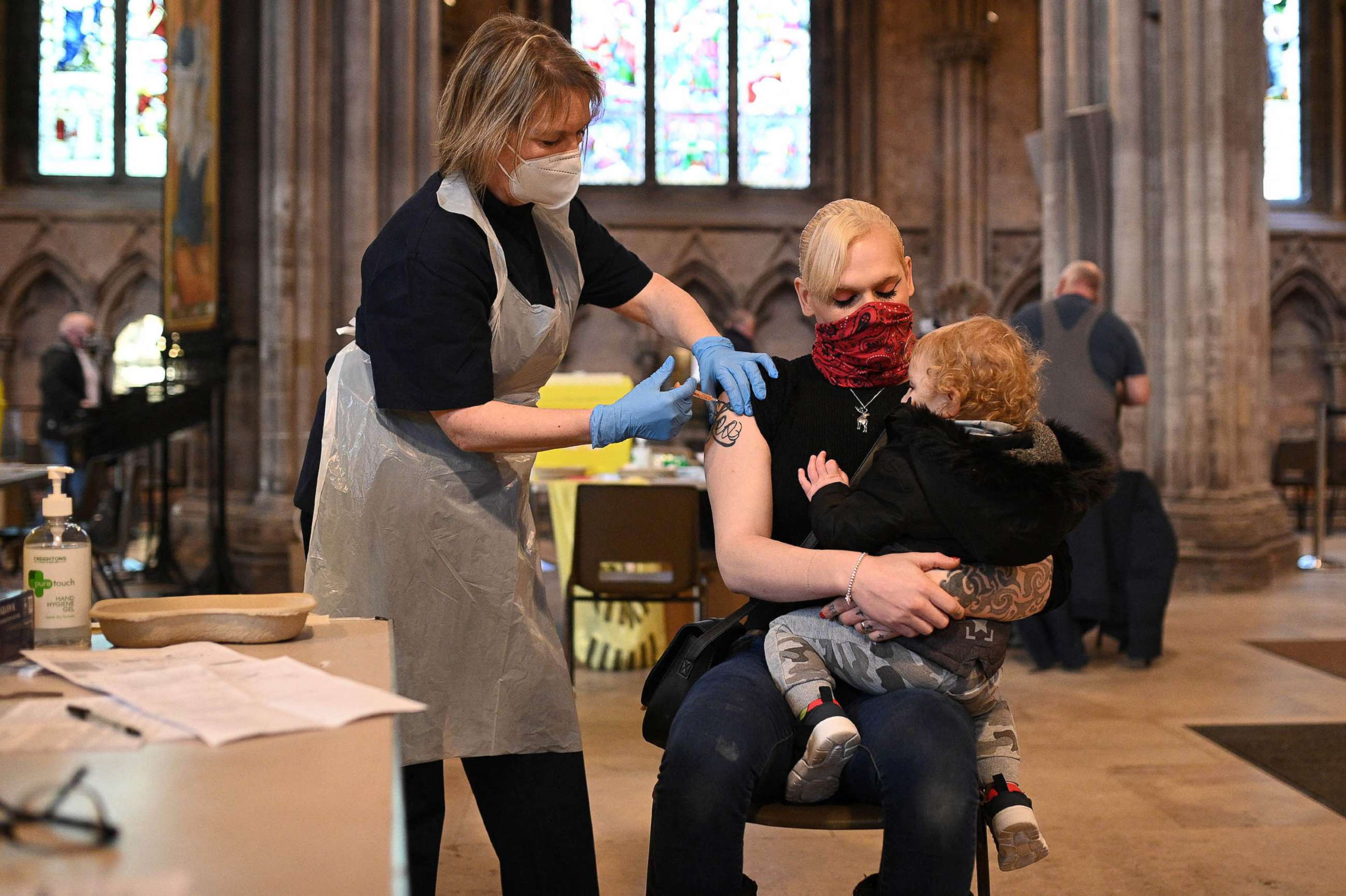PHOTO: Members of the public receive a dose of the AstraZeneca/Oxford Covid-19 vaccine at Lichfield cathedral, which has been converted into a temporary vaccination centre, in Lichfield, England, on March 18, 2021.