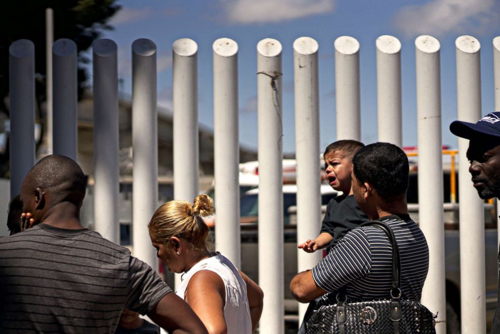 PHOTO: Undocumented migrants wait for asylum hearings outside of the port of entry in Tijuana, Mexico, June 18, 2018.