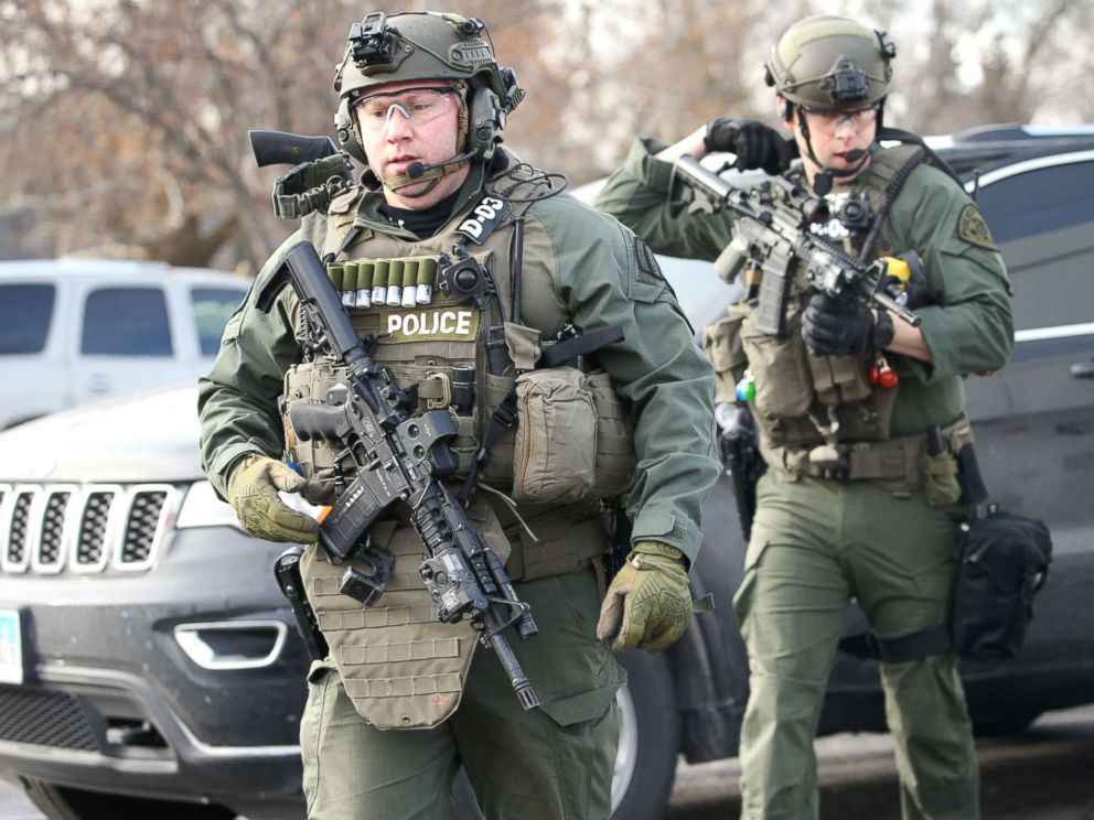 PHOTO: Police officers armed with rifles stage near a commercial building where an active shooter was reported in Aurora, Ill., Feb. 15, 2019.