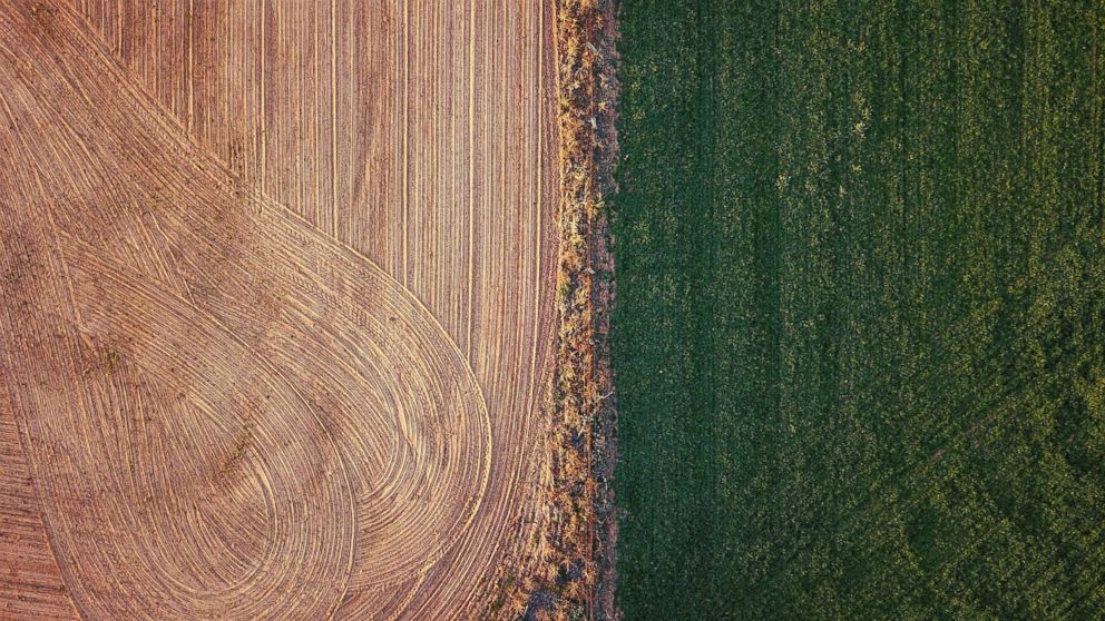 An irrigated paddock can be seen next to a ploughed paddock on a farm located on the outskirts of the town of Mudgee in New South Wales, Australia, July 18, 2018.