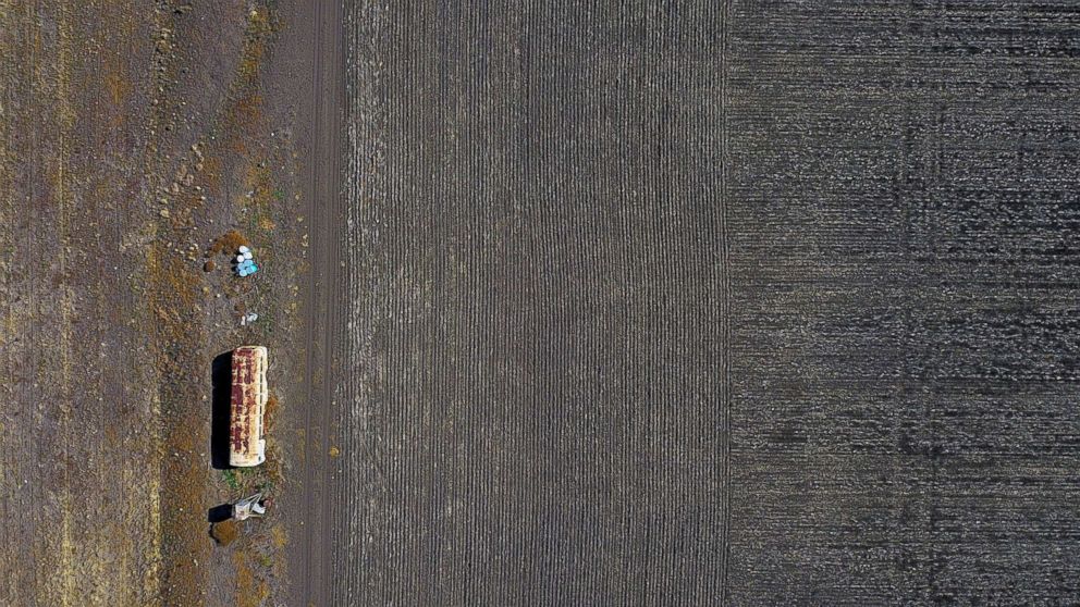 PHOTO: An old bus used for storing farming equipment stands in a drought-effected paddock on a property located west of the town of Gunnedah in New South Wales, Australia, June 3, 2018.