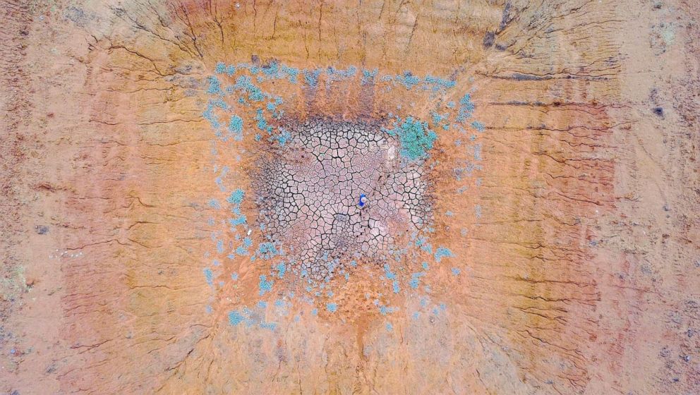 PHOTO: Farmer Ash Whitney stands in the middle of a dried-up dam in a drought-effected paddock on his property located west of the town of Gunnedah in New South Wales, Australia, June 3, 2018.