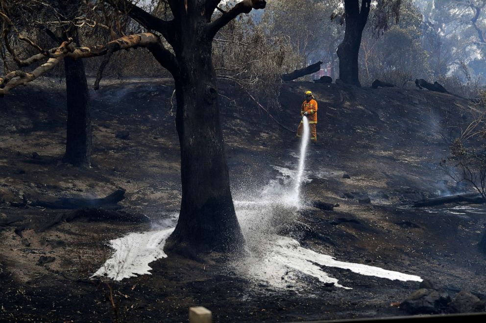 PHOTO: A CFA firefighter is seen as a fire hit Clovemont Way in Bundoora outside Melbourne,Dec. 30, 2019. 