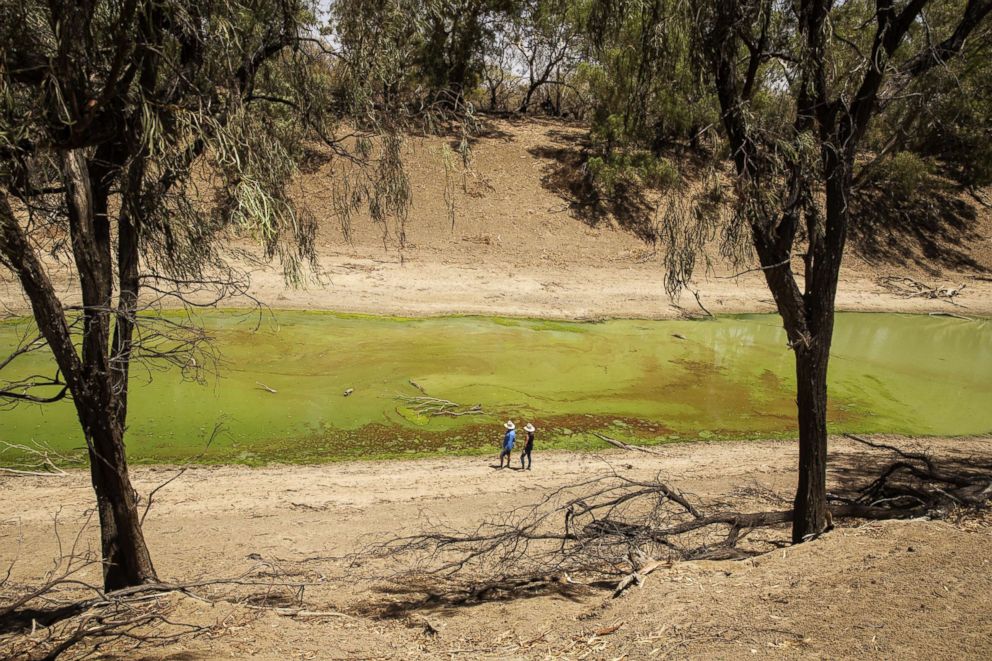 PHOTO: People stand on the banks of the Darling River, which is currently affected by extreme heat, drought and dust in Tilpa, Australia, Jan. 16, 2019.