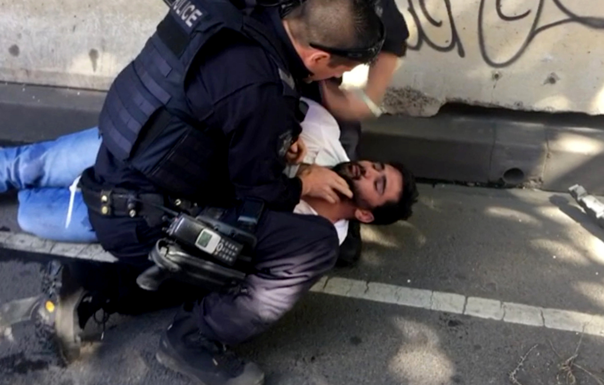 PHOTO: A police officer detains a man that was pulled from the car that rammed pedestrians at Flinders St station in Melbourne, Australia, Dec. 21,  2017.