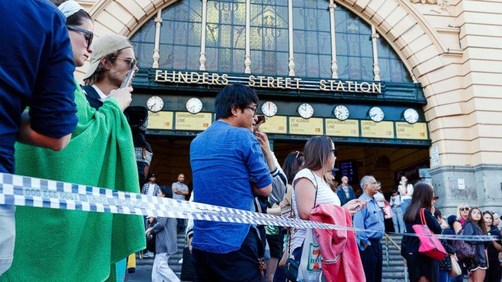 People gather at the scene of where a car ran over pedestrians at Flinders Street in Melbourne, Australia, Dec. 21, 2017.